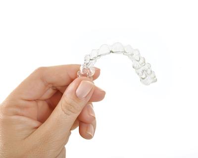 Hand holding up tray of Invisalign in Brisbane CBD