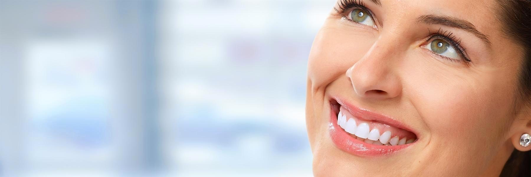 Woman with tooth crowns smiling in Brisbane