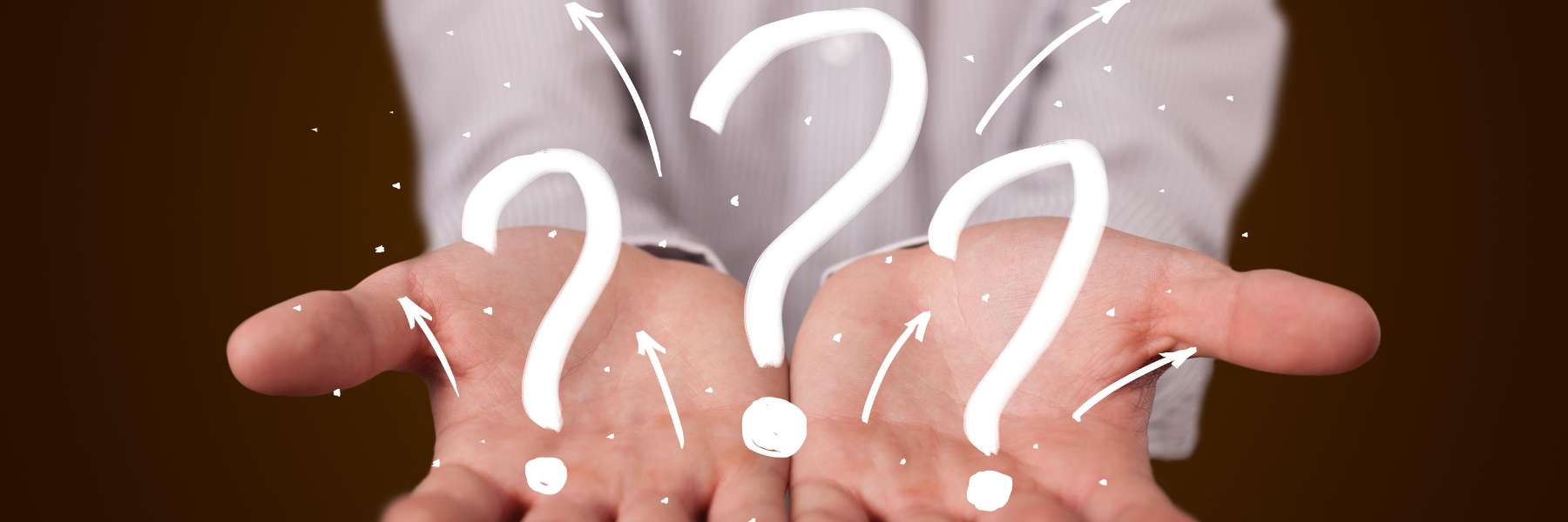 hands holding white questionmarks