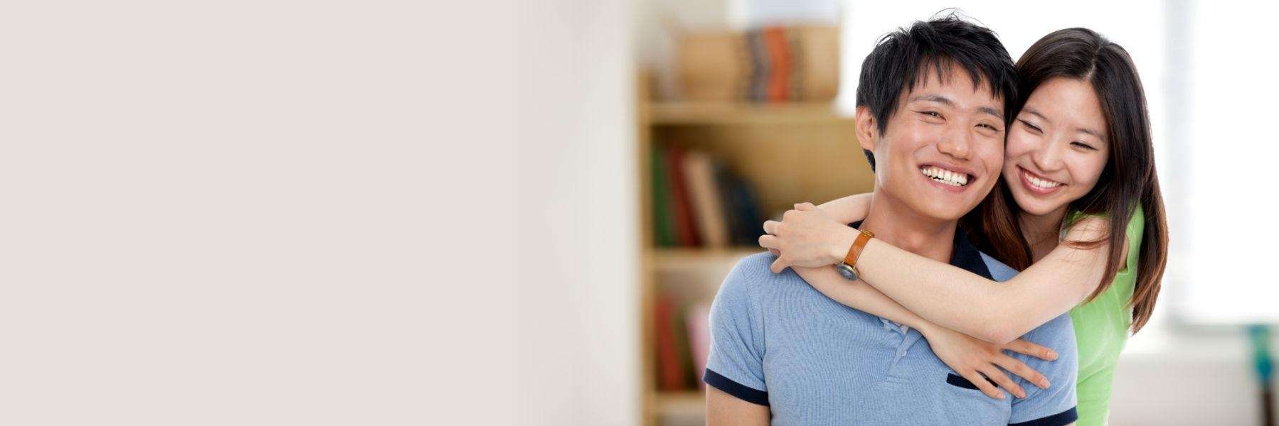 woman hugging her male partner's shoulders 