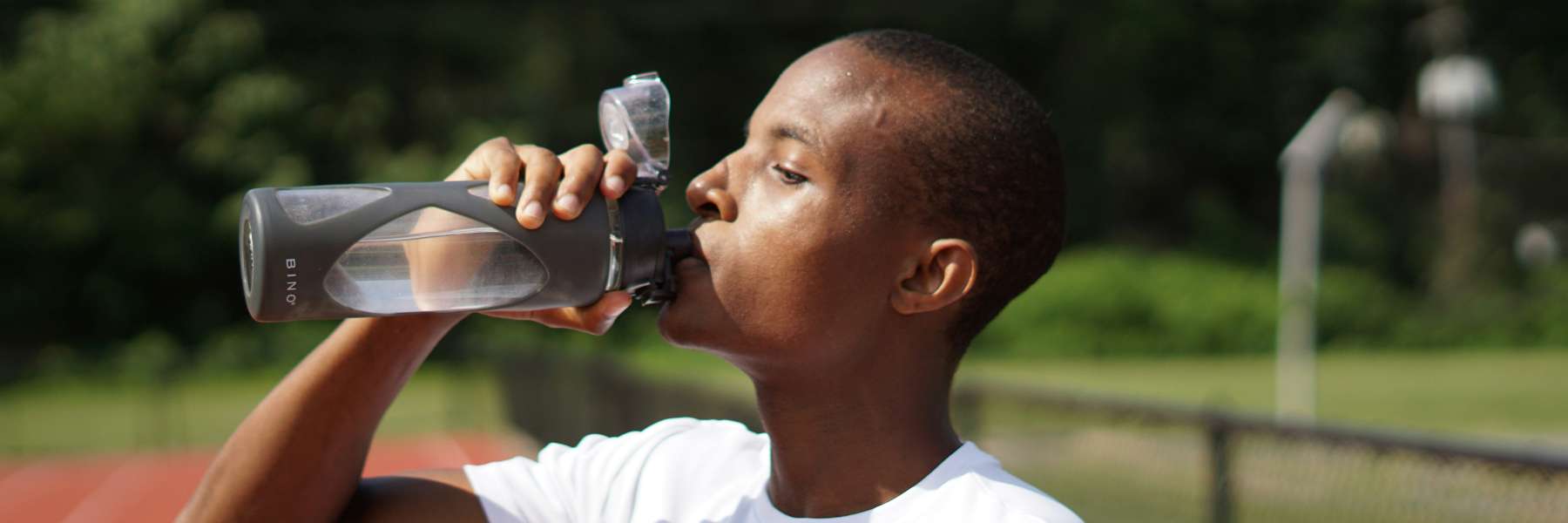 brisbane man drinking from a water bottle