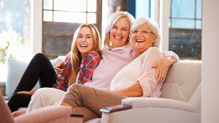 Women laughing on couch at dentist in Brisbane