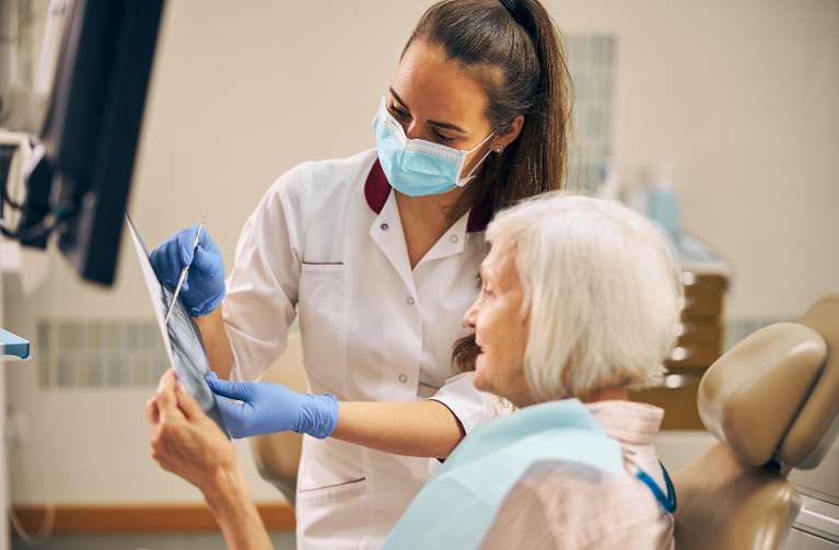 dental hygienist speaking to a patient in brisbane