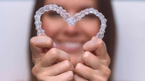 brisbane woman holding invisalign