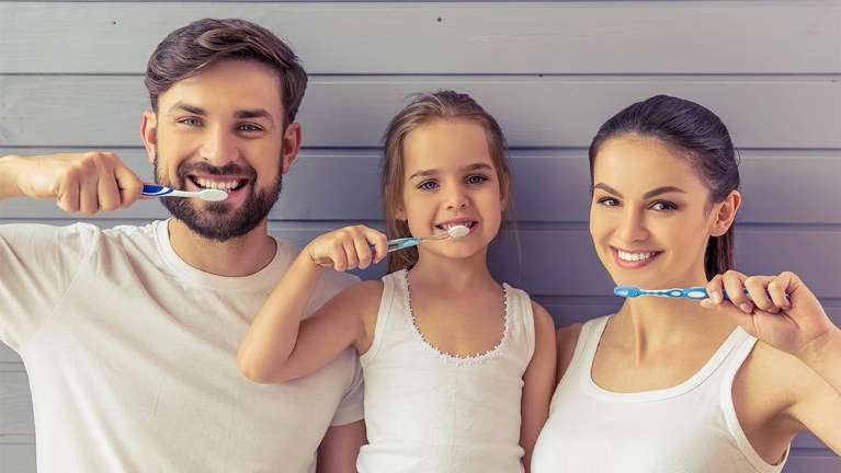 Parents and daughter brushing their teeth in Brisbane CBD