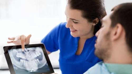 dentist showing a patient some digital xrays