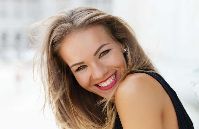 woman smiling after getting veneers in brisbane