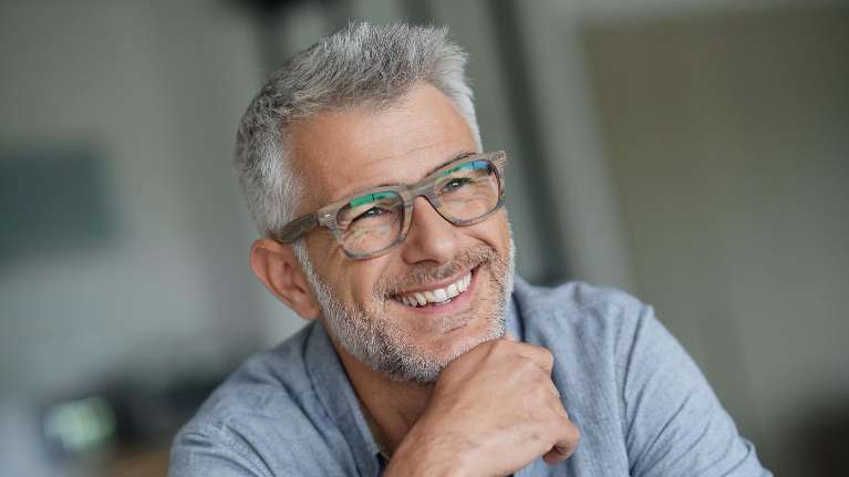 man with glasses smiling