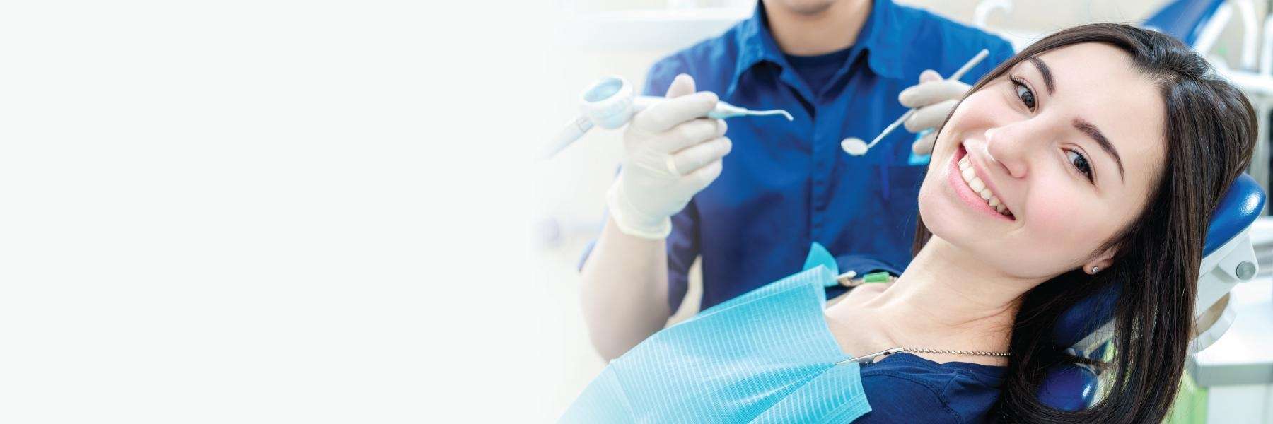 woman smiling in dental chair after cleaning