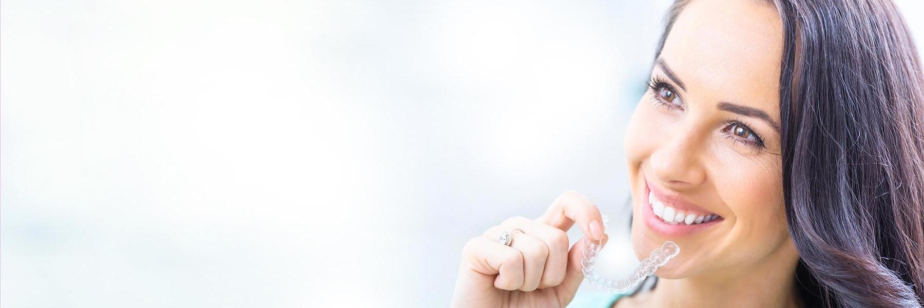 Patient holding tray of Invisalign in Brisbane