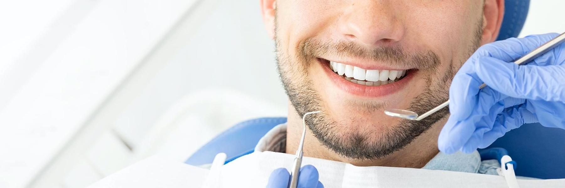 Patient smiling in chair at general dentist in Brisbane