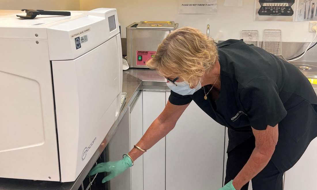 dental team member using sterilisation 